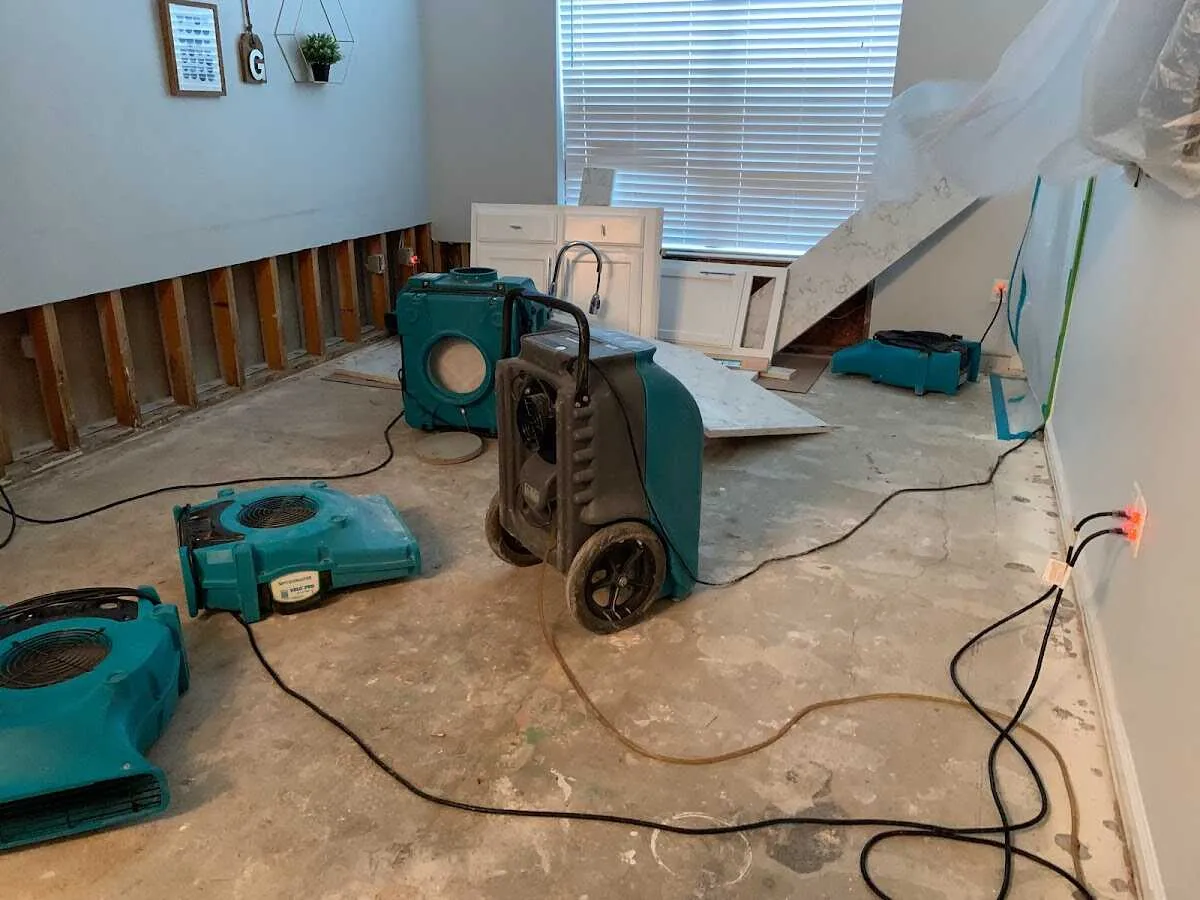 Dehumidifier in flood-cut room for Water Damage Restoration in Rose